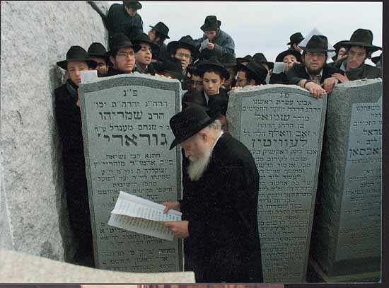 The Rebbe reading letters at the Ohel